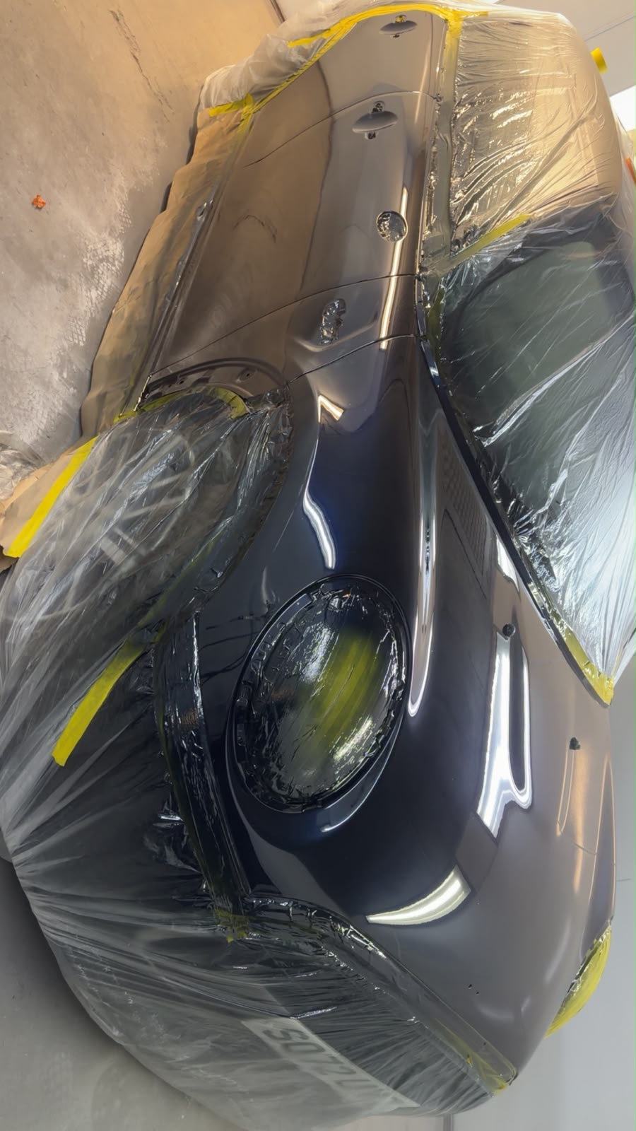 Dark car masked for bodywork painting